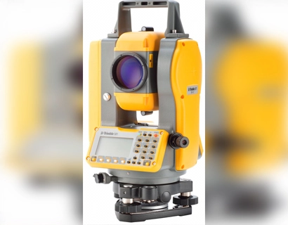 Yellow and grey mechanical total station for measuring angles and distances in surveying.